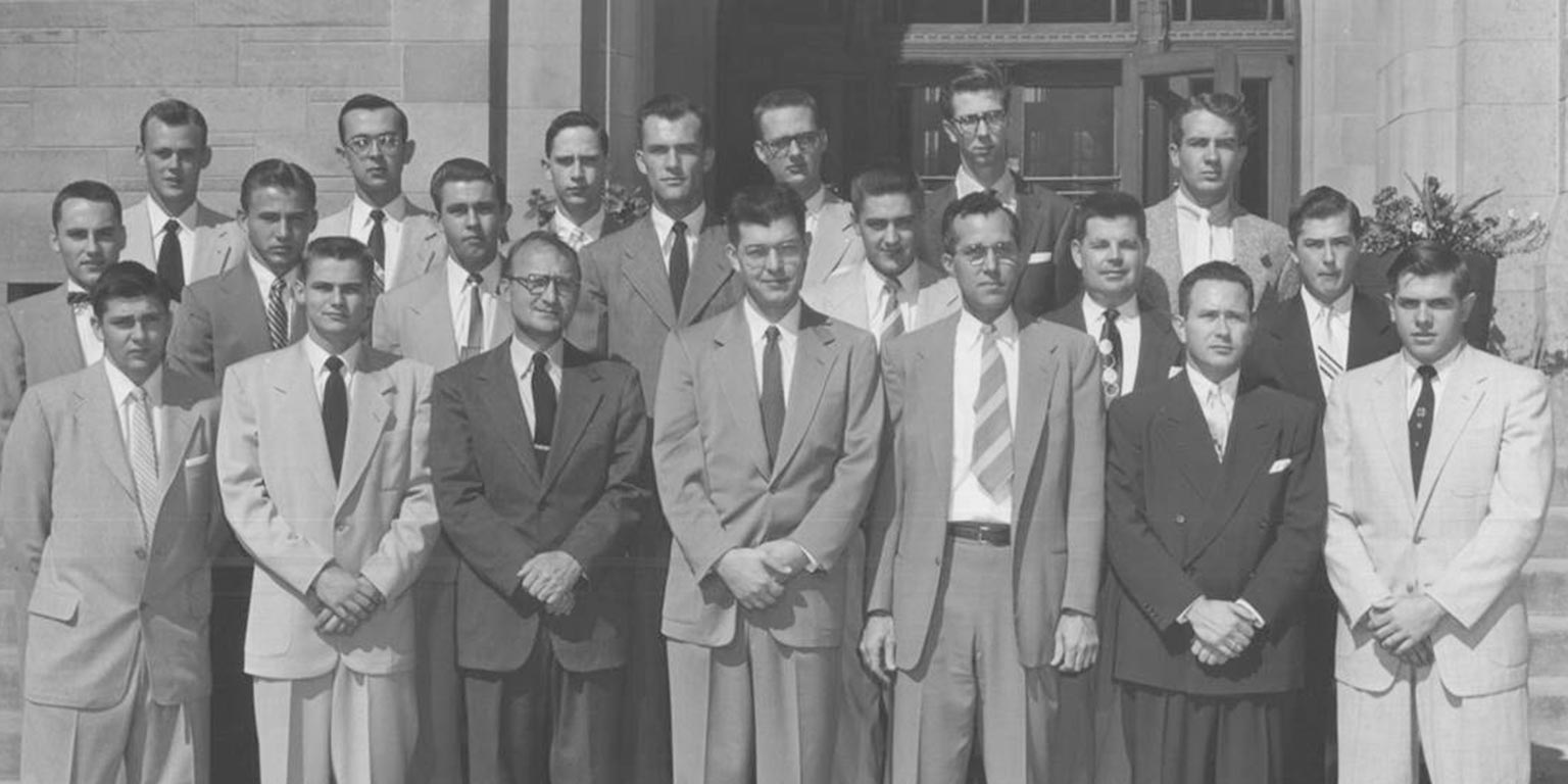 IU School of Optometry Class of 1956. Twenty men wearing suits and ties.