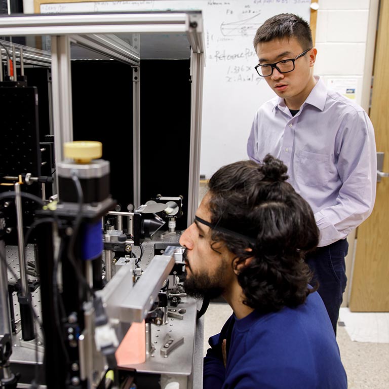 Two optometry students perform research in the Miller Lab.