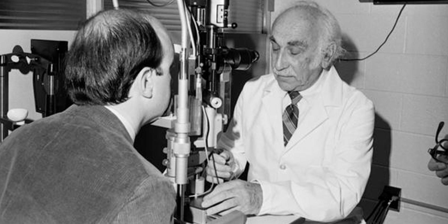 Irvin M. Borish examines a patient. Black and white archive image.