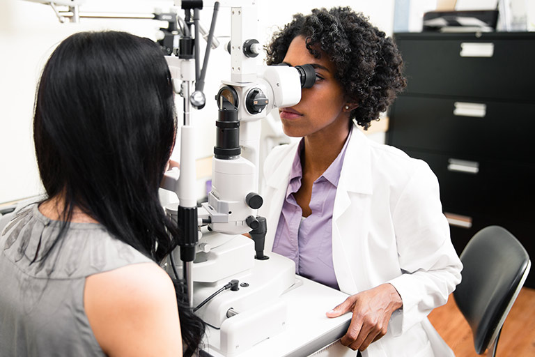 An optometry student performs an eye exam