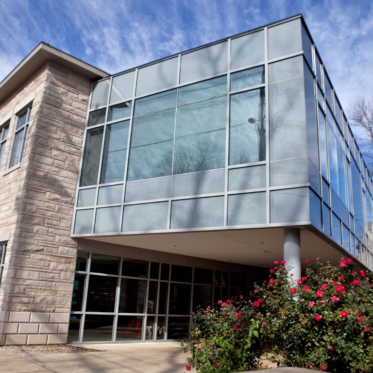 Exterior photo of the Atwater Eye Care Clinic, a limestone building with many windows